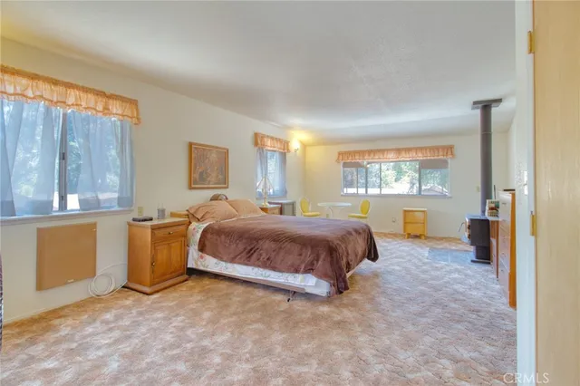 a bed sitting in a bedroom next to a window