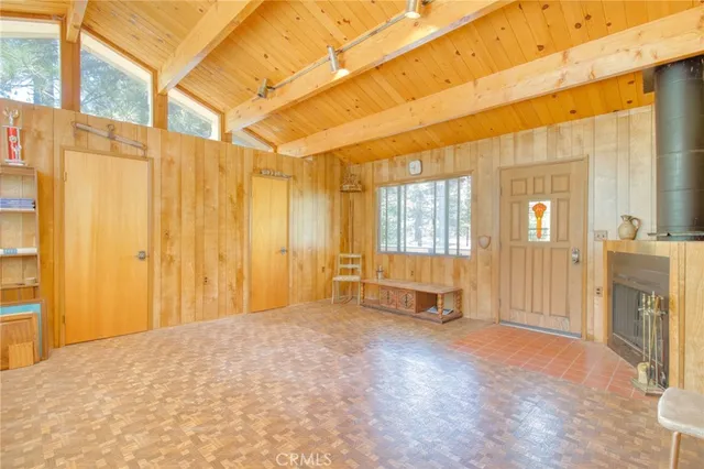 a view of a balcony with chairs and wooden floor
