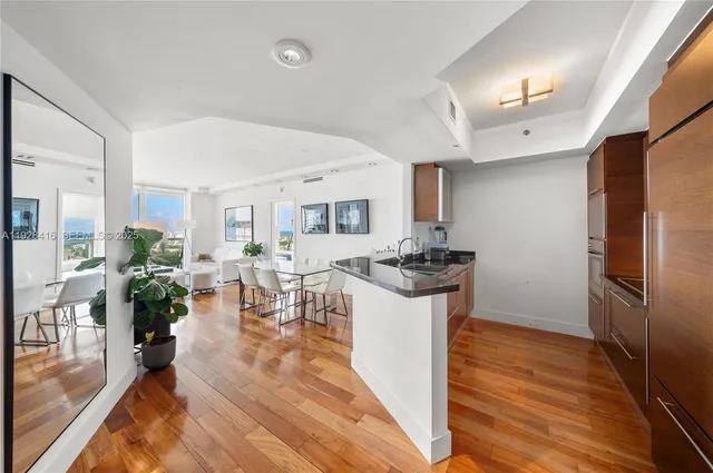 a kitchen with sink refrigerator and stove