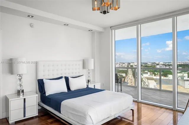 a bedroom with a large bed and a large window