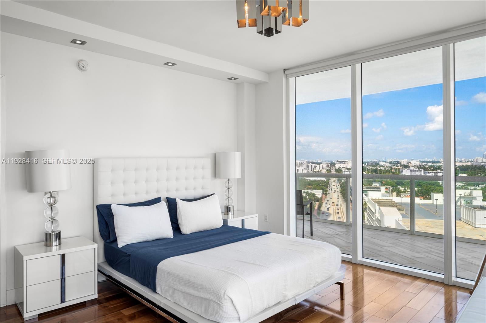 450 Alton Road, Unit 1610 Miami Beach, FL 33139 - Photo 15 of 32 a bedroom with a large bed and a large window