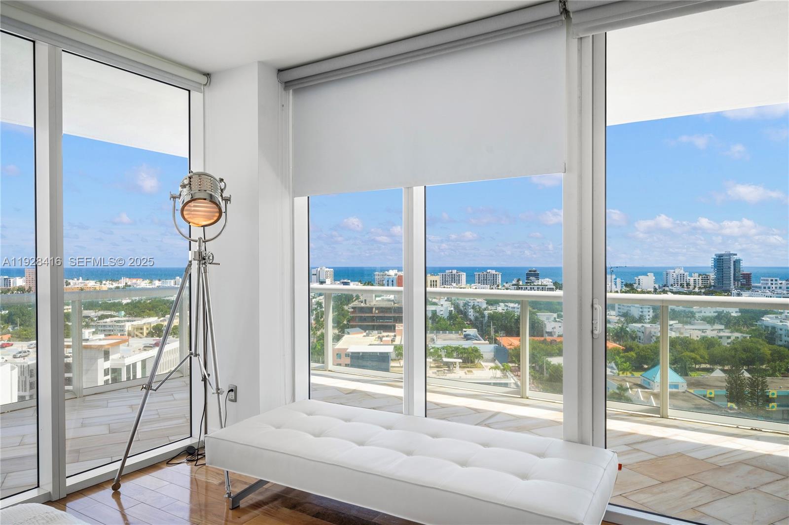 450 Alton Road, Unit 1610 Miami Beach, FL 33139 - Photo 16 of 32 a view of a room with balcony and floor to ceiling window