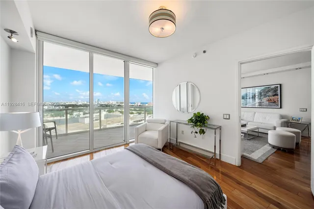 a bedroom with a large bed and a large window