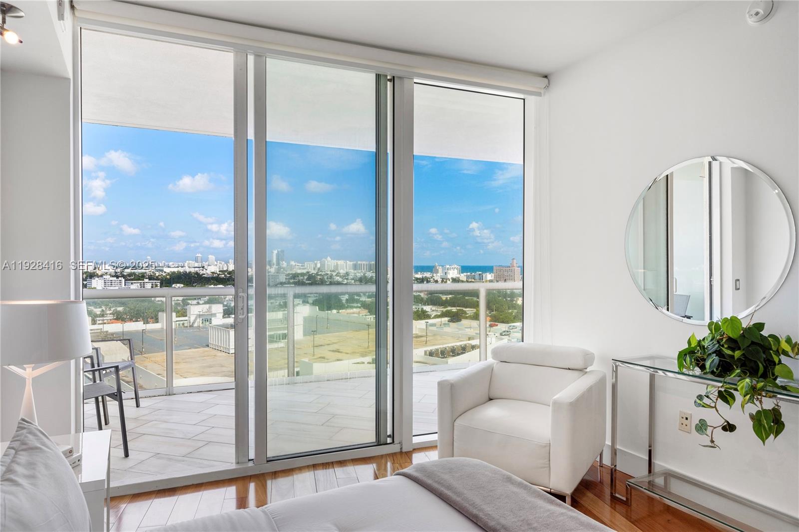 450 Alton Road, Unit 1610 Miami Beach, FL 33139 - Photo 20 of 32 a living room with furniture and a floor to ceiling window