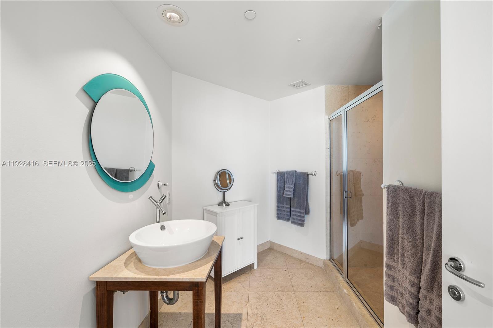 450 Alton Road, Unit 1610 Miami Beach, FL 33139 - Photo 21 of 32 a bathroom with a sink and a mirror