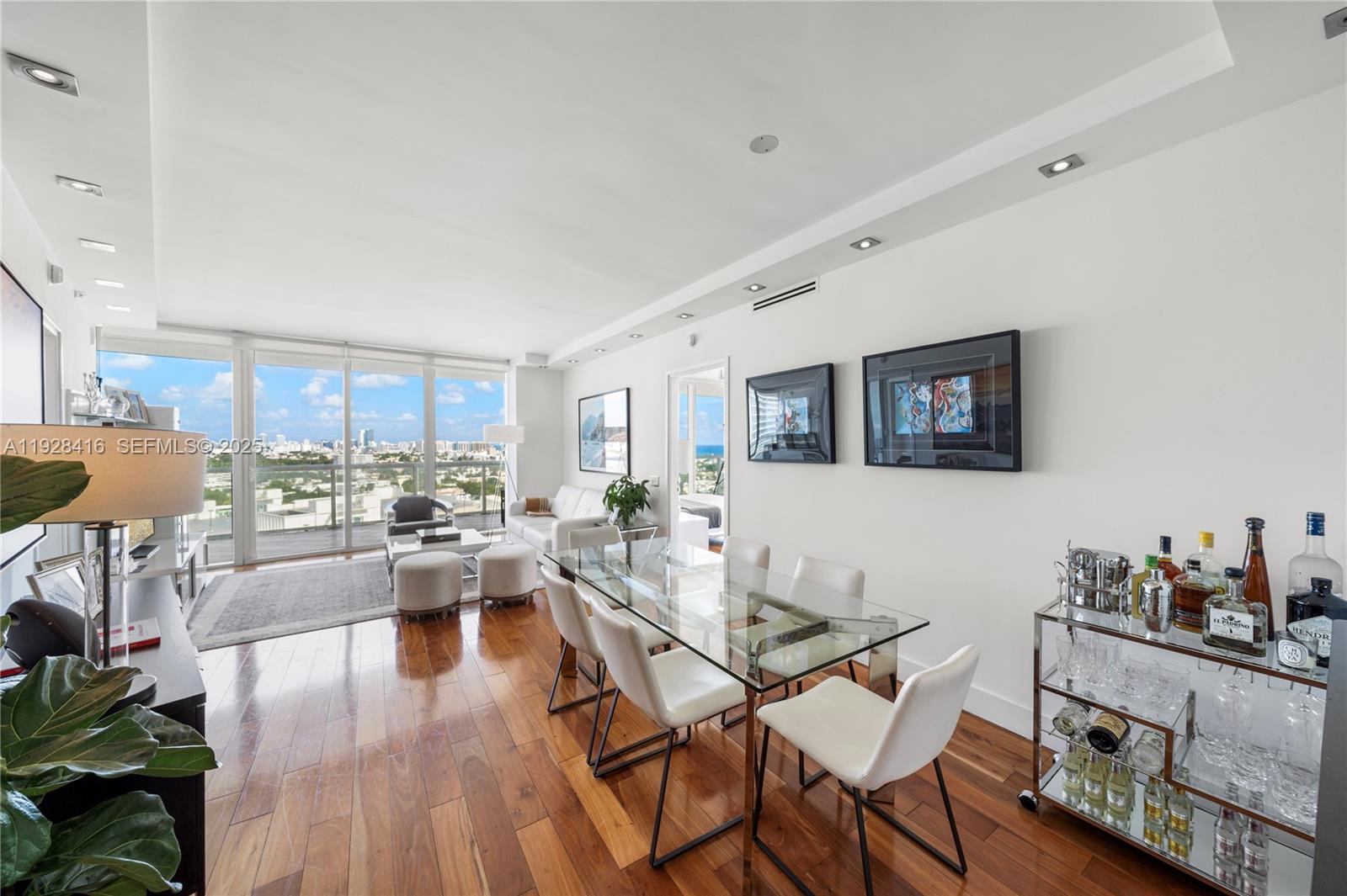 450 Alton Road, Unit 1610 Miami Beach, FL 33139 - Photo 6 of 32 a living room with fireplace furniture and a wooden floor