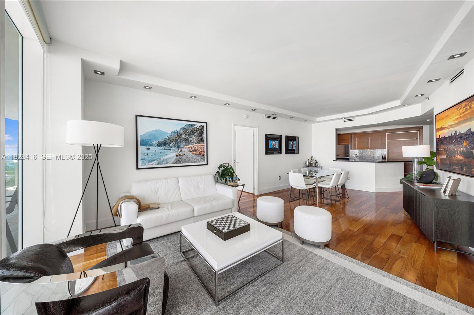 450 Alton Road, Unit 1610 Miami Beach, FL 33139 - Photo 9 of 32 a living room with furniture a lamp and a large window