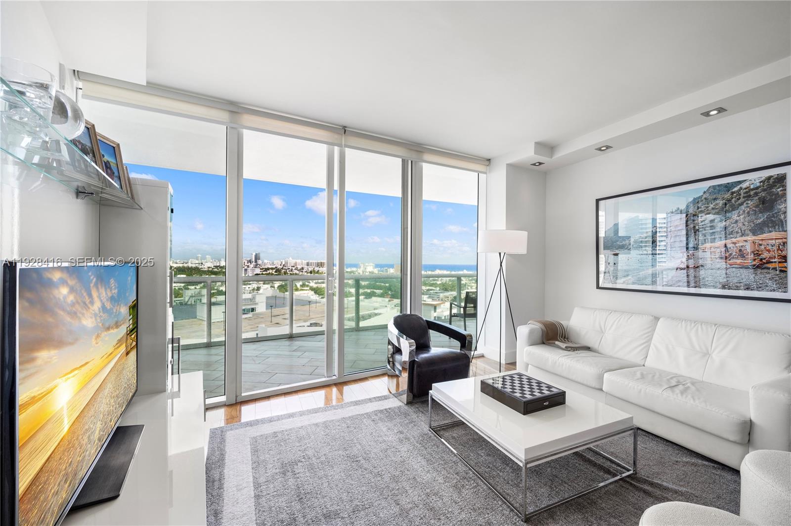 450 Alton Road, Unit 1610 Miami Beach, FL 33139 - Photo 10 of 32 a living room with furniture and a large window