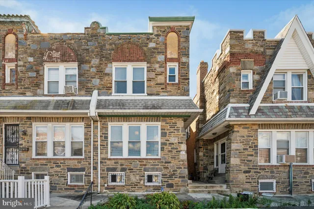 a view of a brick building next to a yard