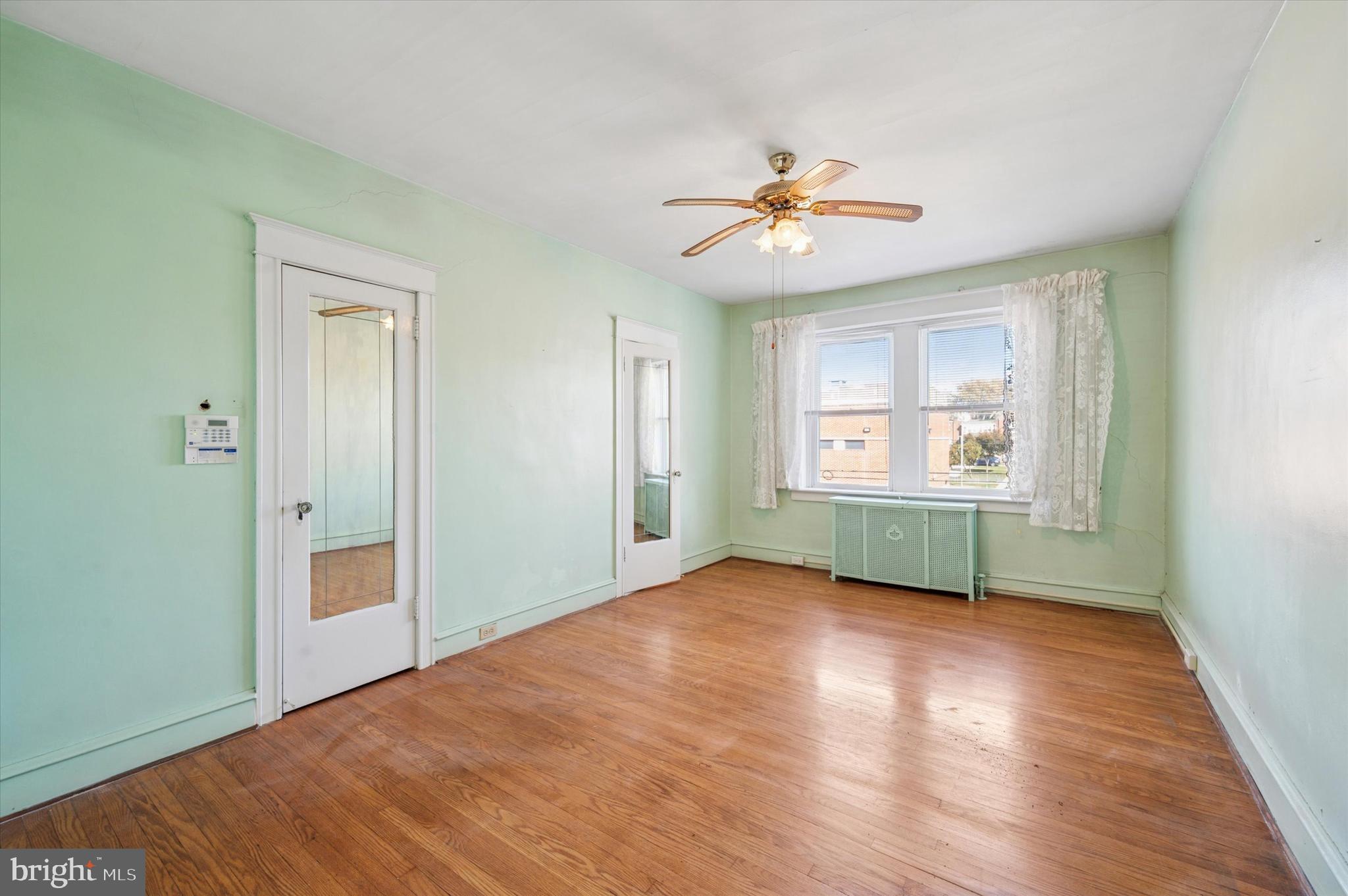 262 Bayard Road Upper Darby, PA 19082 - Photo 18 of 25 a view of an empty room with window and wooden floor