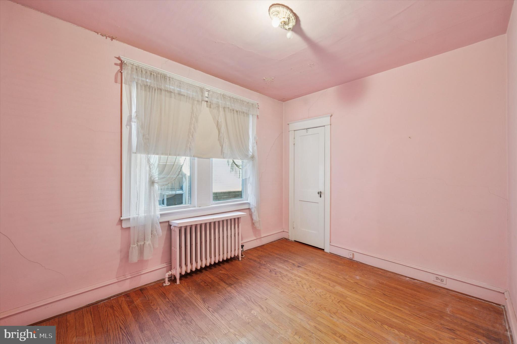 262 Bayard Road Upper Darby, PA 19082 - Photo 21 of 25 an empty room with wooden floor and windows