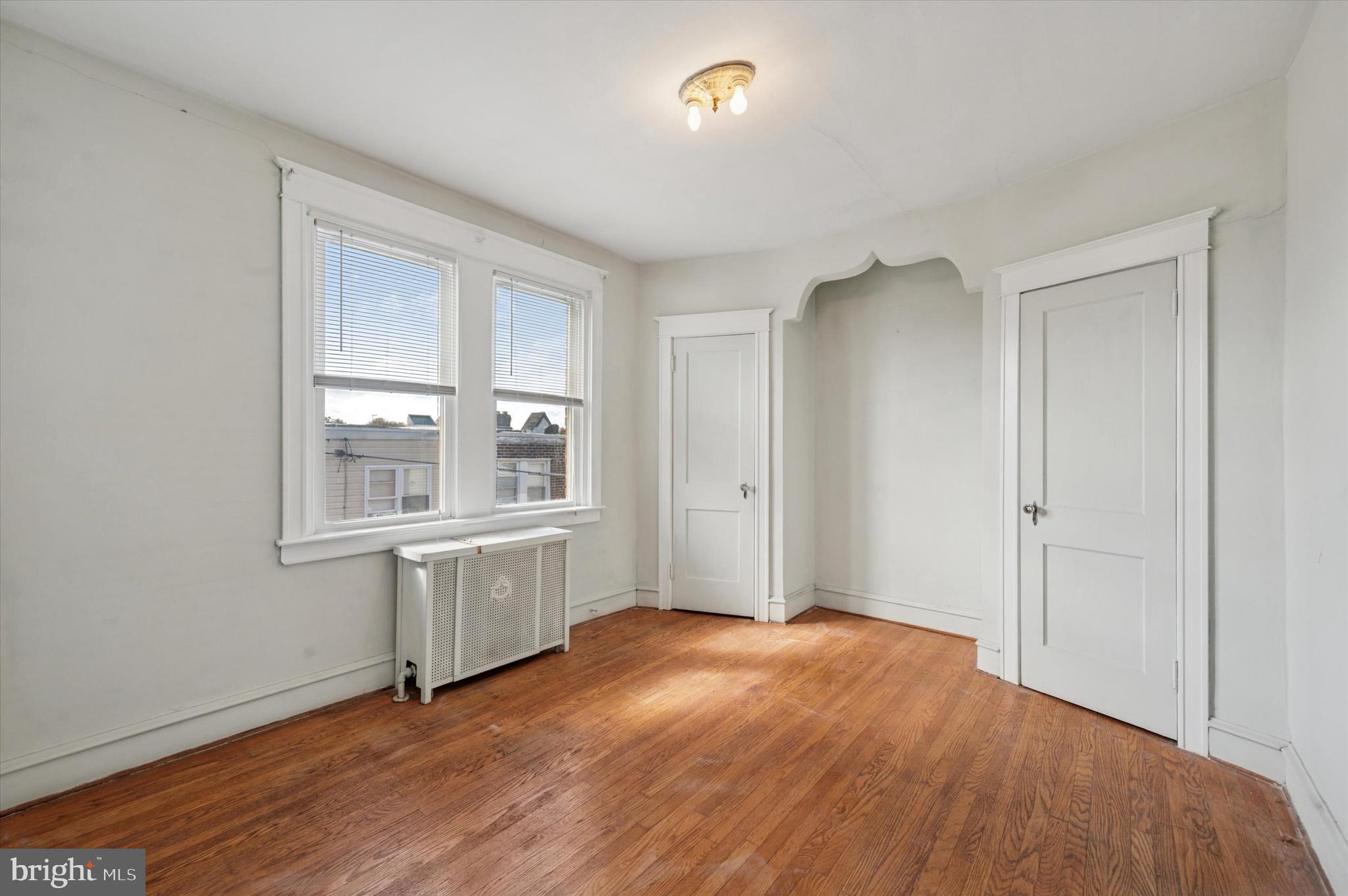 262 Bayard Road Upper Darby, PA 19082 - Photo 24 of 25 an empty room with wooden floor and window