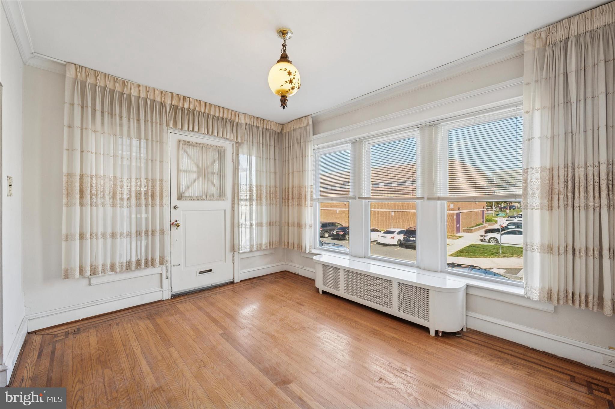 262 Bayard Road Upper Darby, PA 19082 - Photo 3 of 25 wooden floor in an empty room with a window