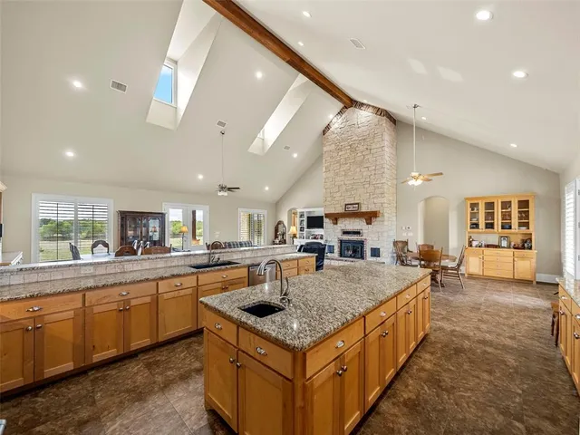 a kitchen with a stove sink and cabinets