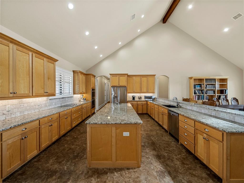453 Tower Road Valley View, TX 76272 - Photo 17 of 38 a large kitchen with granite countertop lots of counter space and windows