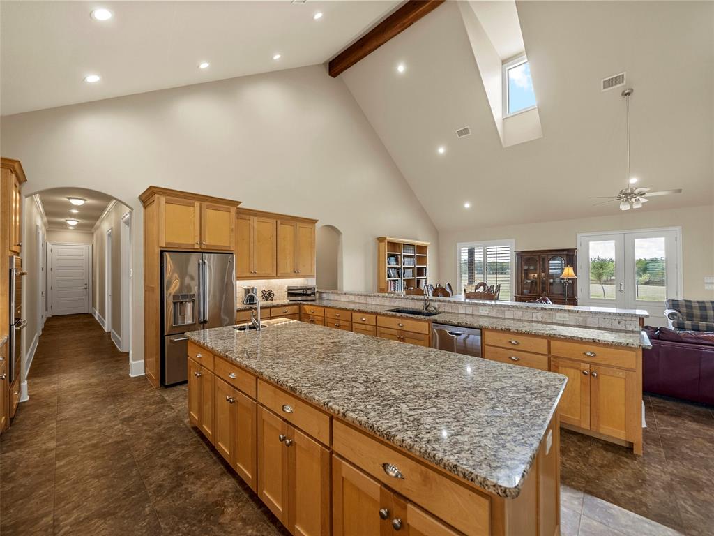 453 Tower Road Valley View, TX 76272 - Photo 18 of 38 a large kitchen with kitchen island a sink appliances and a counter top space