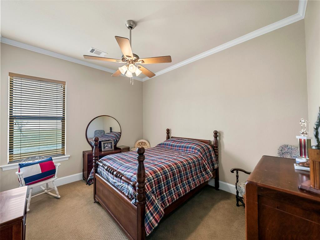 453 Tower Road Valley View, TX 76272 - Photo 25 of 38 a bedroom with a bed and a chandelier
