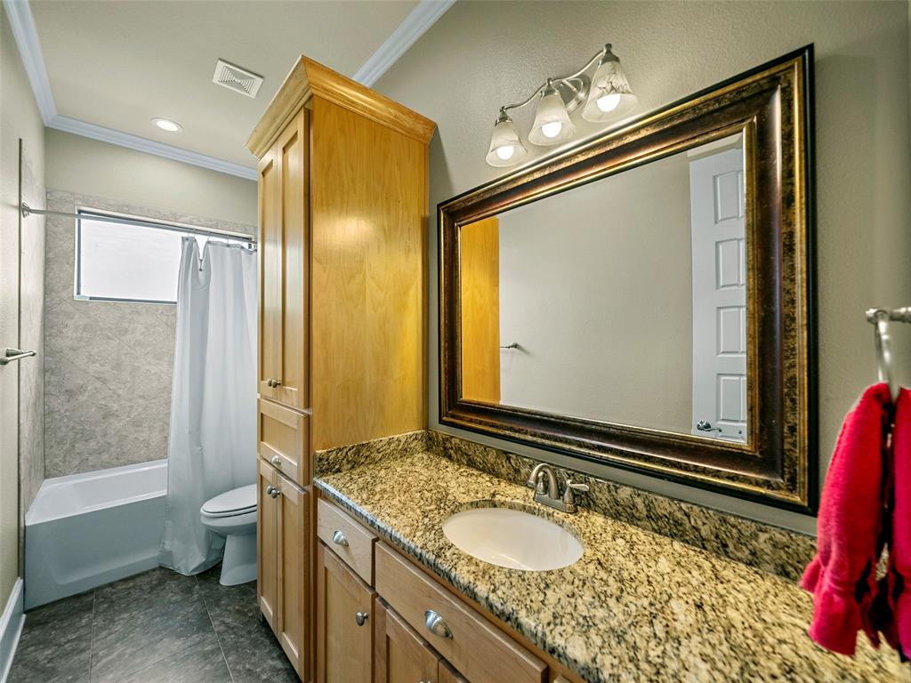 453 Tower Road Valley View, TX 76272 - Photo 26 of 38 a bathroom with a granite countertop sink toilet and shower