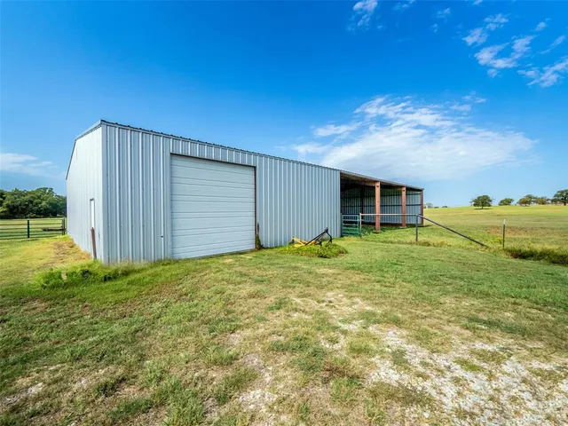 a view of a house with backyard and garage