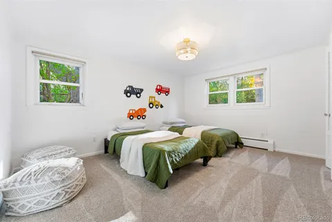 a bedroom with two beds and a window