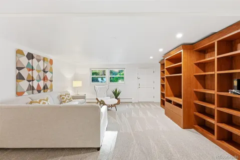a living room with a couch and bookshelf