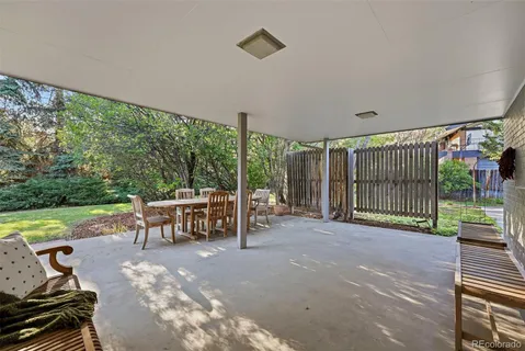 a view of a garden with lawn chairs