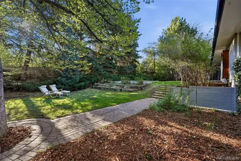 a view of a house with a yard and sitting area