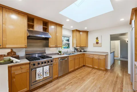 a kitchen with stainless steel appliances granite countertop a stove and a sink
