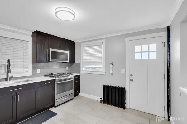 a kitchen with a sink and a stove top oven
