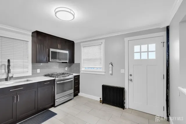 a kitchen with a sink and a stove top oven