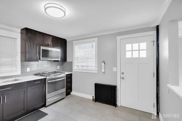 a kitchen with a sink stainless steel appliances and cabinets