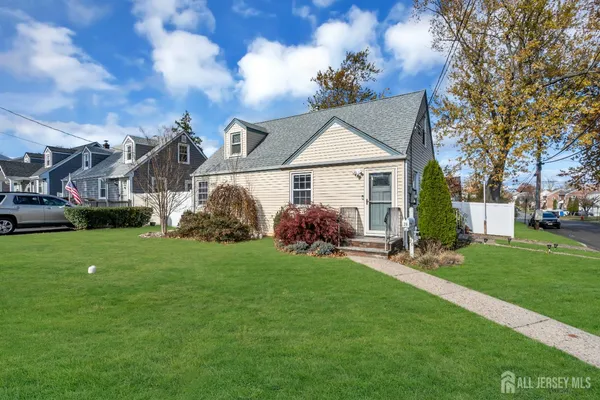 a view of a house with a yard and sitting area