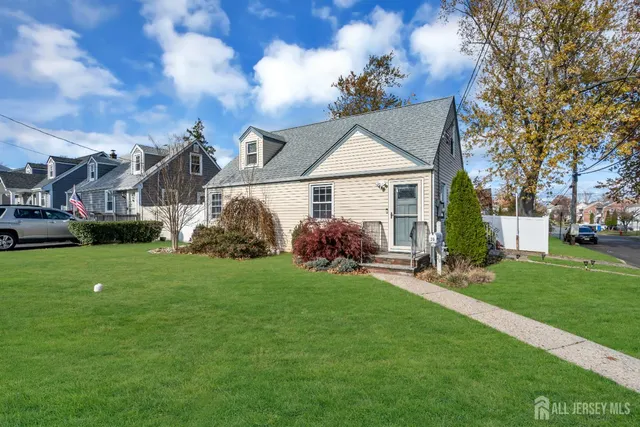 a view of a house with a yard and sitting area