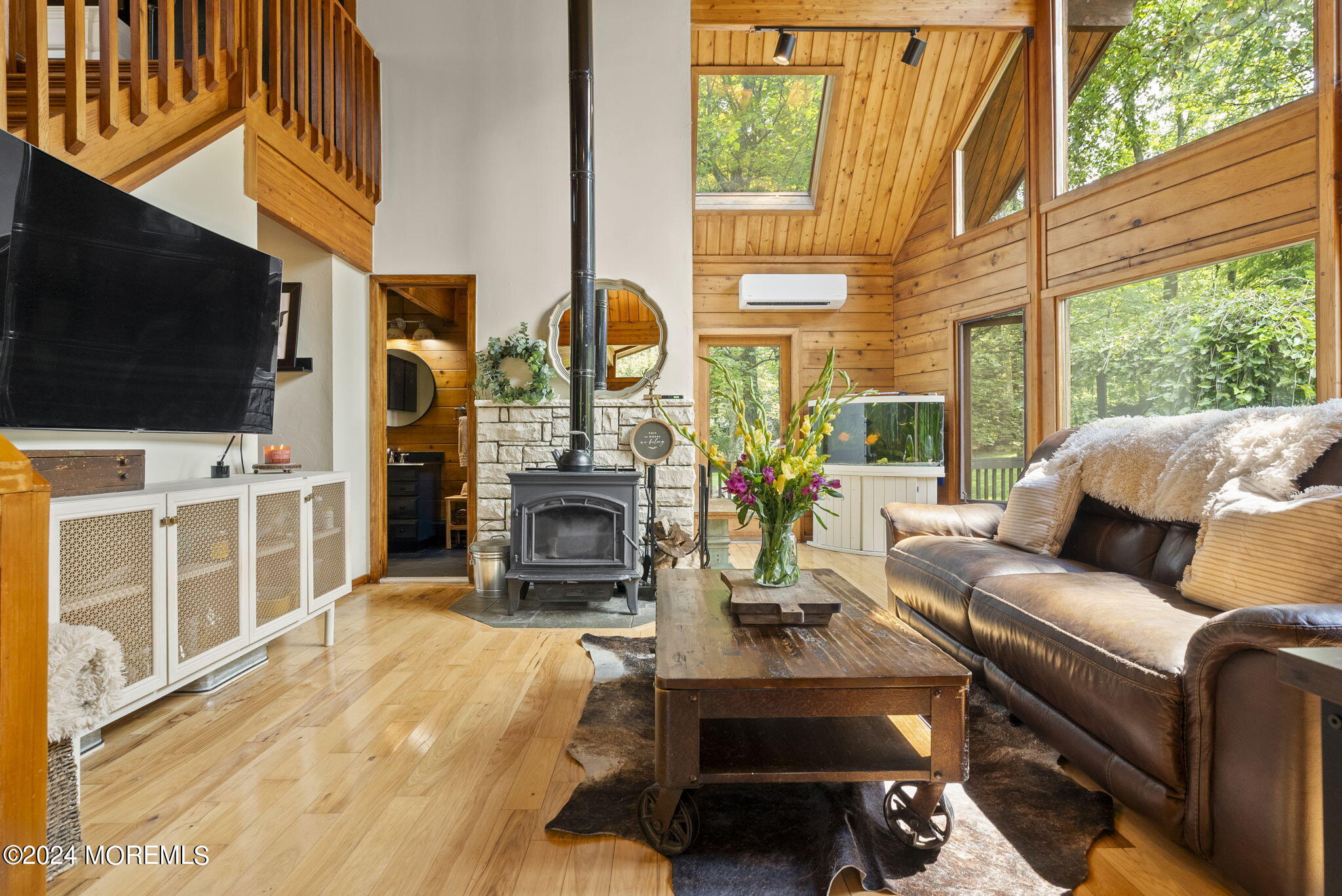 151 Summerfield Road Belvidere, NJ 07823 - Photo 8 of 41 a living room with furniture a flat screen tv and a floor to ceiling window