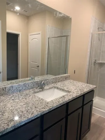 a kitchen with granite countertop a sink cabinets and window
