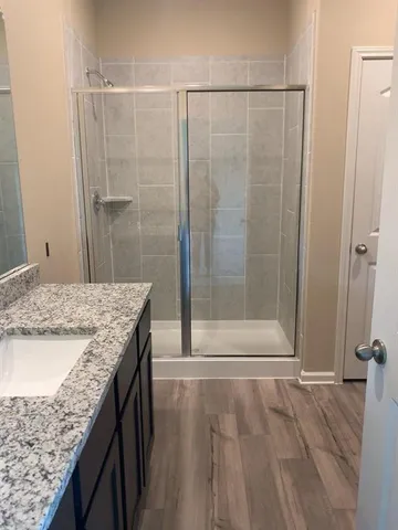 a bathroom with a granite countertop sink and a mirror