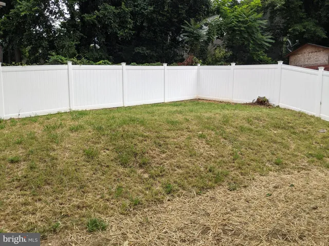 a view of yard with large trees