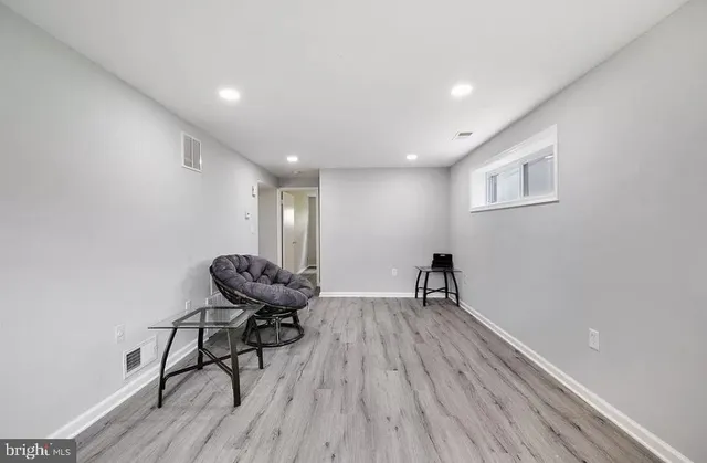 a view of a workspace with furniture and wooden floor