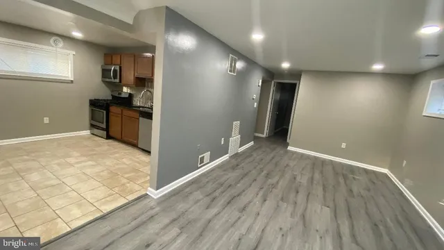 a view of a kitchen with a sink and wooden floor