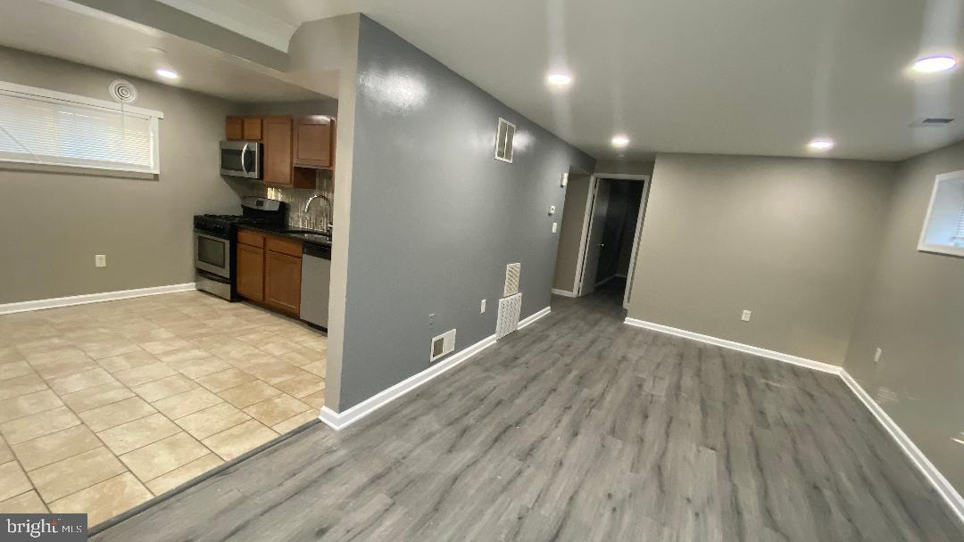 4616 Heath Street, Unit B Capitol Heights, MD 20743 - Photo 3 of 25 a view of a kitchen with a sink and wooden floor