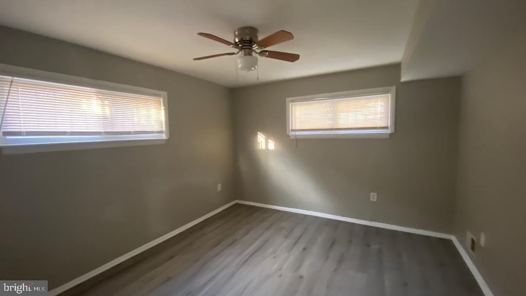 4616 Heath Street, Unit B Capitol Heights, MD 20743 - Photo 5 of 25 an empty room with wooden floor and windows