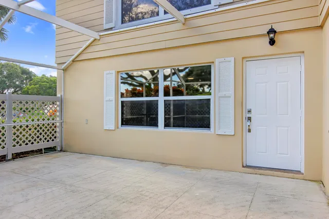 an empty room with a large window and chandelier