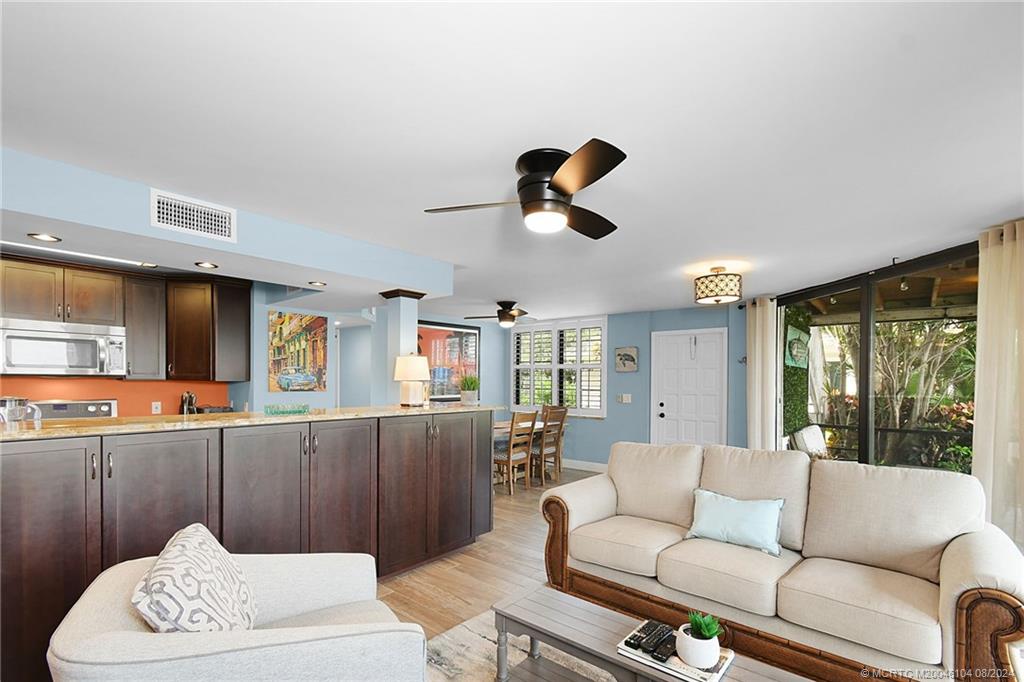 311 Golfview Circle Stuart, FL 34996 - Photo 12 of 37 a living room with furniture and a large window