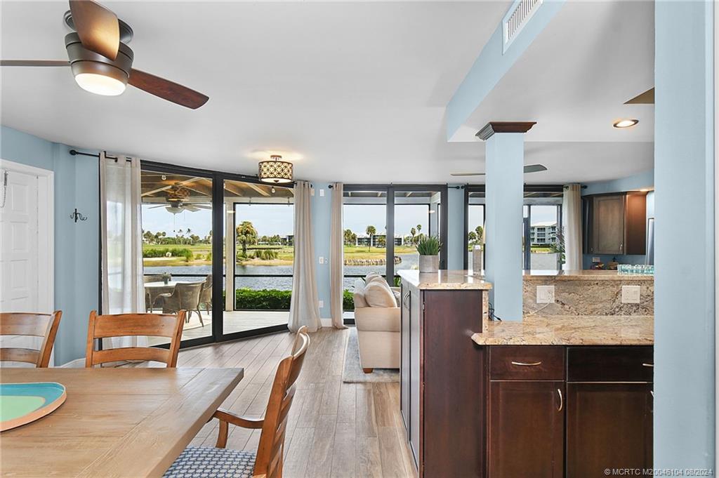 311 Golfview Circle Stuart, FL 34996 - Photo 17 of 37 a living room with furniture large windows and wooden floor