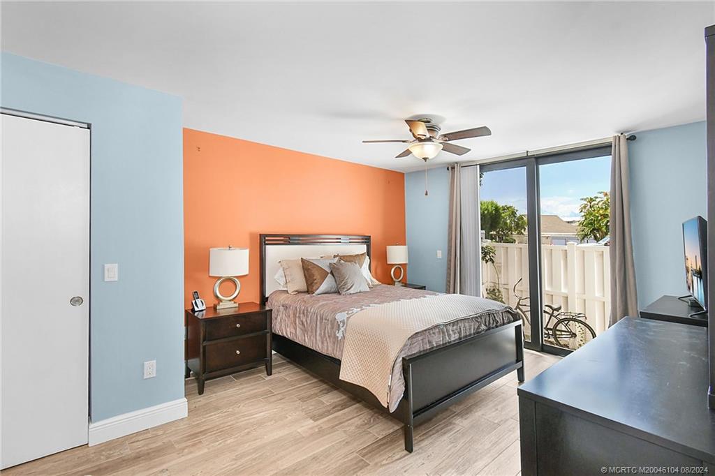 311 Golfview Circle Stuart, FL 34996 - Photo 18 of 37 a bedroom with a bed and a table