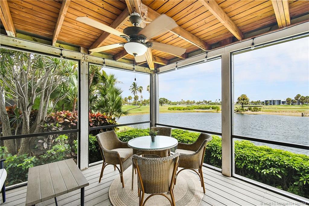 311 Golfview Circle Stuart, FL 34996 - Photo 24 of 37 a view of a porch with furniture and a yard