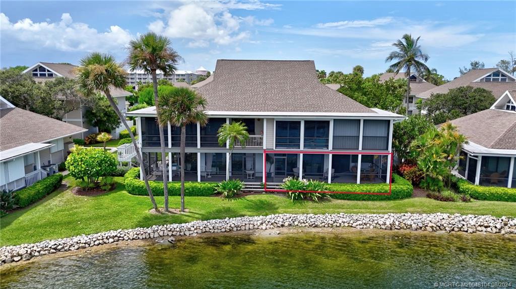 311 Golfview Circle Stuart, FL 34996 - Photo 29 of 37 a front view of a house with a yard and potted plants