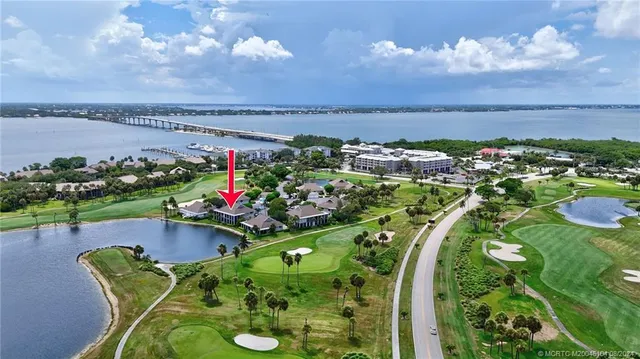 an aerial view of a swimming pool a playground and lake view