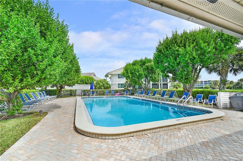 311 Golfview Circle Stuart, FL 34996 - Photo 32 of 37 a view of a swimming pool with a patio