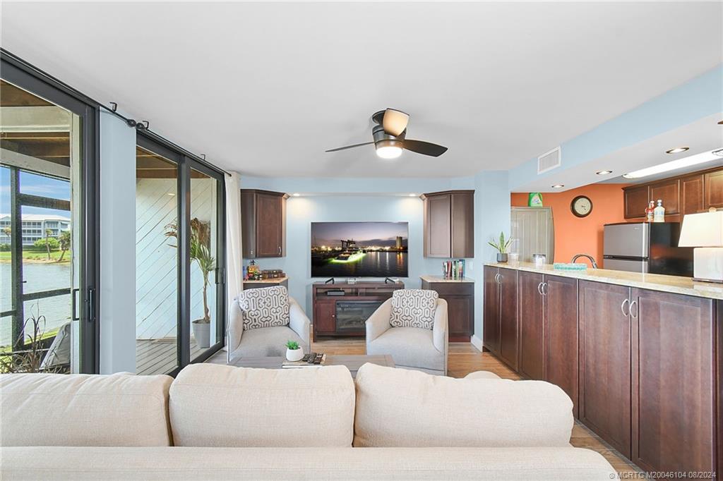 311 Golfview Circle Stuart, FL 34996 - Photo 6 of 37 a living room with furniture and a large window